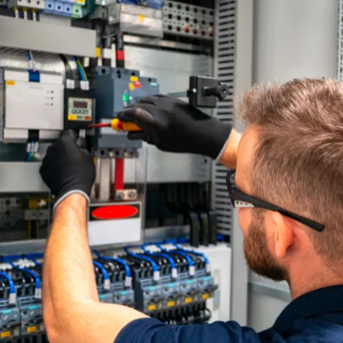 Picture of a man working on an electrical mains unit