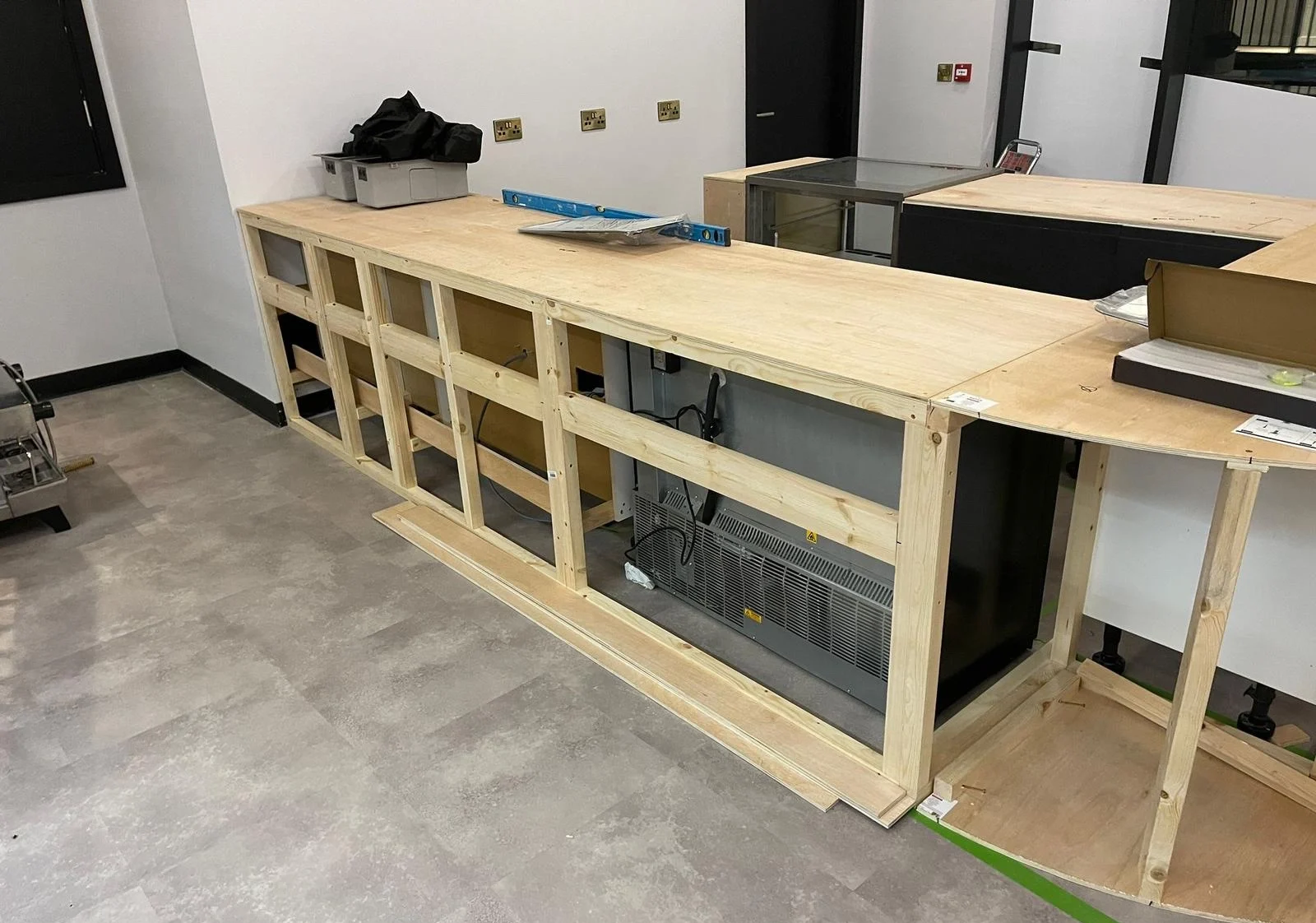 Cafe counter under construction with exposed wood boards