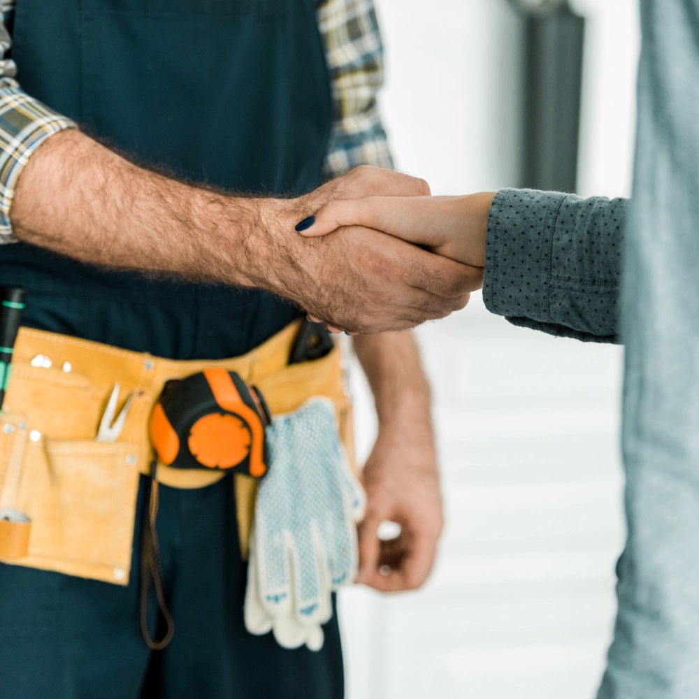 Picture of a plumber and customer shaking hands